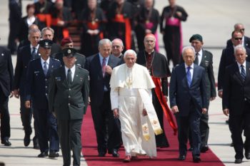 Pope Benedict XVI is flanked by Israeli Prime Minister Benjamin Netanyahu, left, and President Shimon Peres upon his arrival at Ben Gurion International Airport on May 11, 2009.

 (Flash90 / JTA)