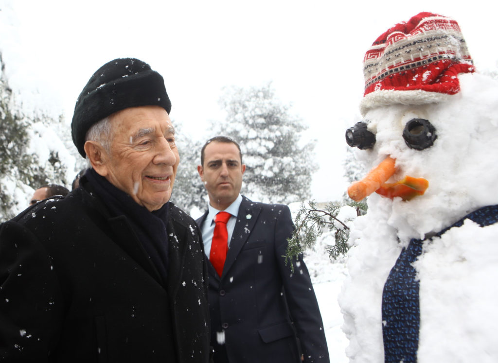 Israeli President Shimon Peres and a snowman in the garden of Peres' residence, Jan. 10, 2013. (Kobi Gideon/GPO/FLASH90/JTA)