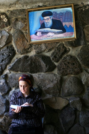 A Jewish woman reading and praying at the burial place of the Rambam in Tiberias.  (Chen Leopold/Flash 90)