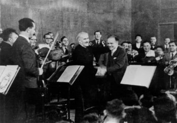 Arturo Toscanini, left, and Bronislaw Huberman on stage after the first Palestine Symphony concert in 1936, as seen in "Orchestra of the Exiles," a film by Josh Aronson. (Courtesy of the Felicja Music Center Library/Huberman Archive)