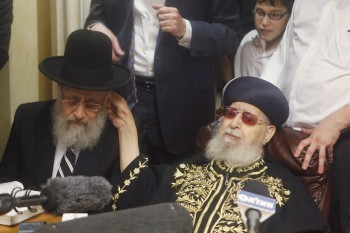 Shas spiritual leader Rabbi Ovadia Yosef, right, congratulating his son, newly elected Sephardic Chief Rabbi Yitzhak Yosef, at Ovadia Yosef's Jerusalem residence, July 24, 2013. (Flash90/JTA)