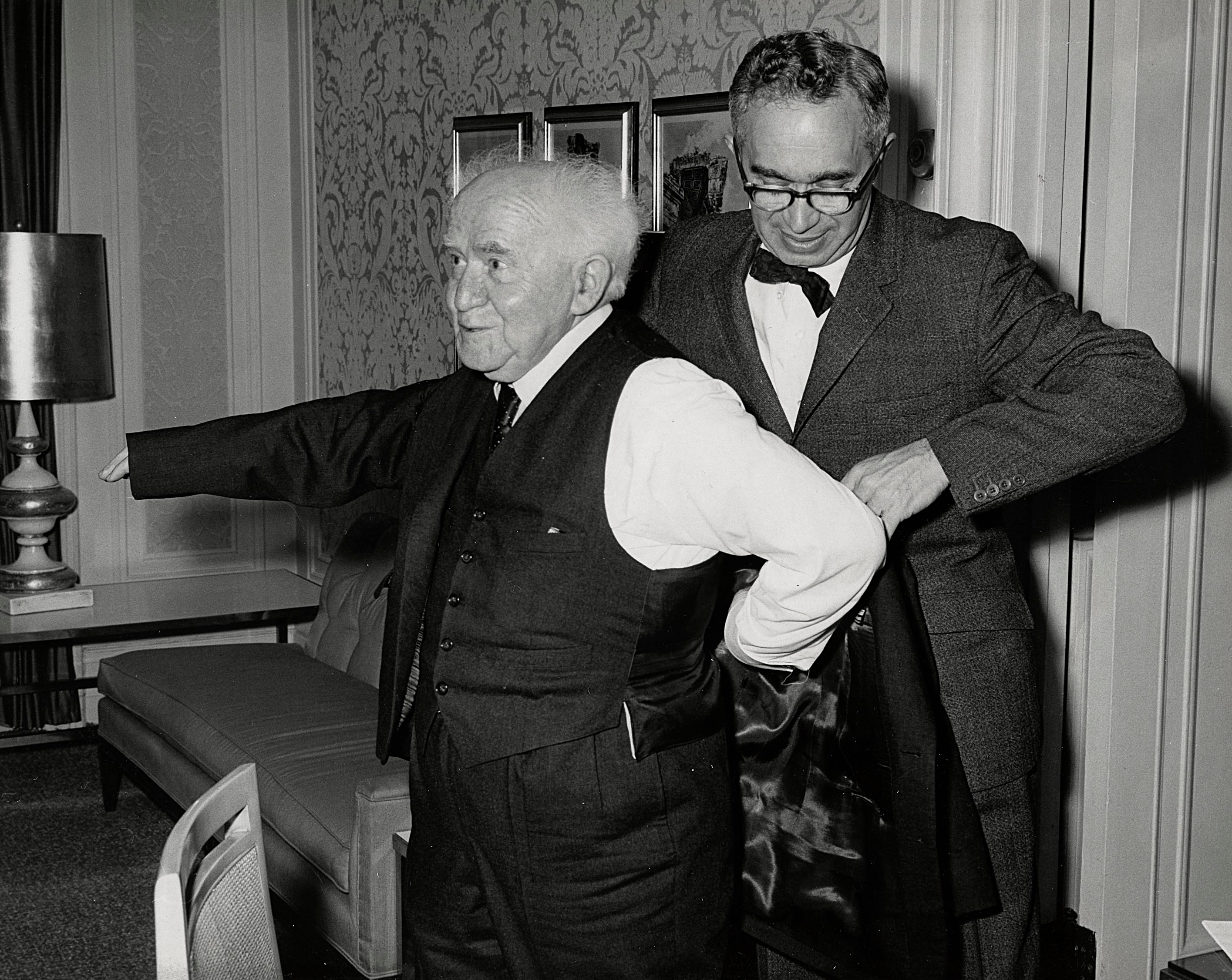 This photo of Ralph Goldman assisting Israeli Prime Minister David Ben-Gurion with his coat in the 1950s is called 