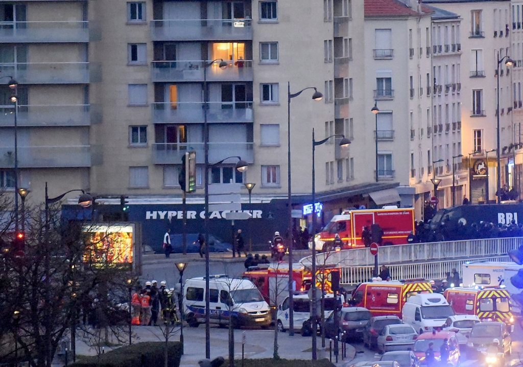 French firemen and emergency responders enter a kosher supermarket during the hostage situation at Port de Vincennes in Paris, Jan. 9, 2015. (Antoine Antoniol/Getty Images)