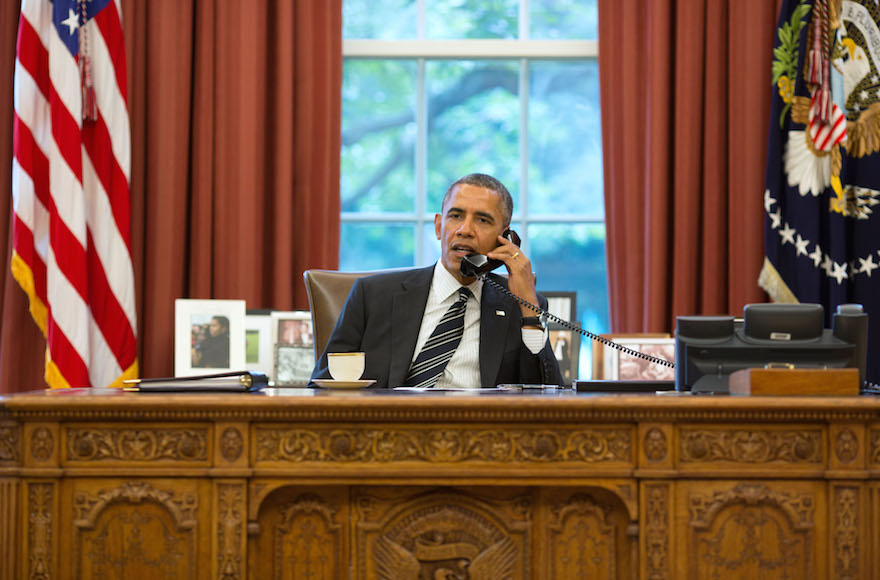 President Barack Obama talks with President Hassan Rouhani of Iran during a phone call in the Oval Office, Sept. 27, 2013. (Pete Souza/Getty Images)  