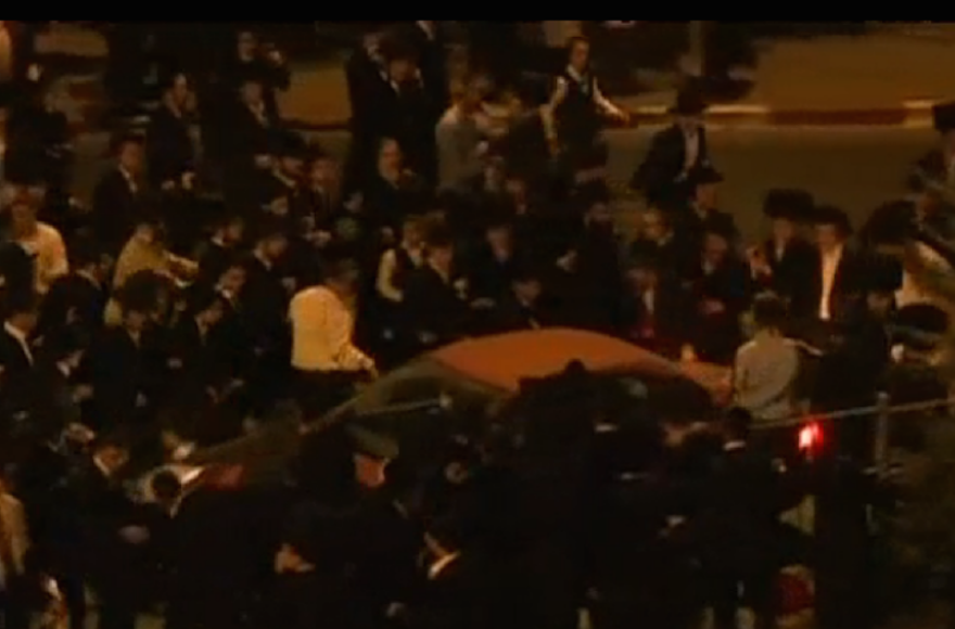 Haredi Orthodox men clashing with police at a protest against the opening of a multiplex cinema on Shabbat, in Jerusalem, on August 14, 2015. (Screenshot: Channel 10)