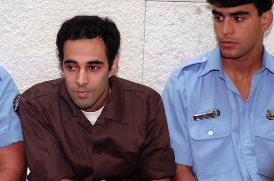 Yigal Amir, convicted for the murder of Israeli Prime Minister Yitzhak Rabin is flanked by two prison warders at the first hearing of his appeal to the Israeli Supreme Court in Jerusalem, July 7 1996. (Eyal Warshavsky/AP Images)