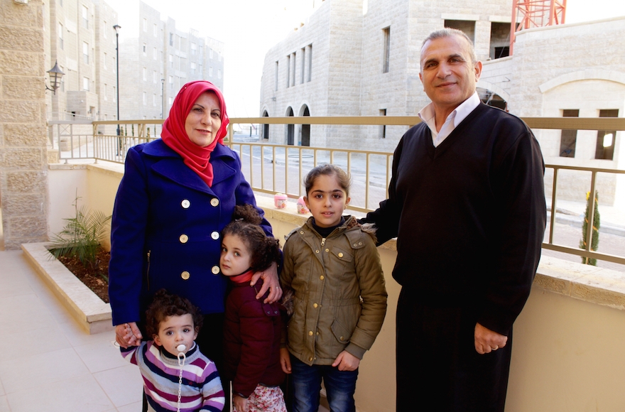 Basim Dodin, right, and his wife Asma are among the first Palestinian residents of Rawabi. (Yardena Schwartz)