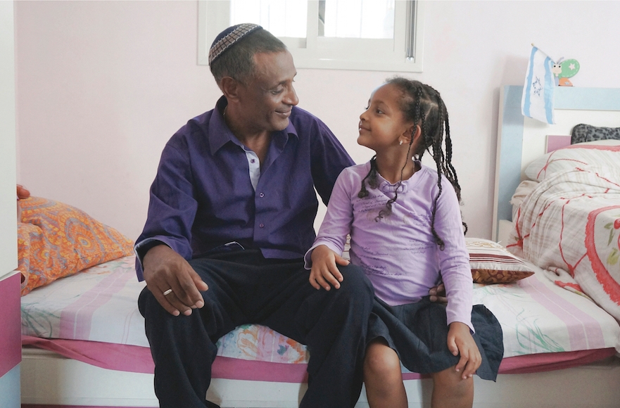 Amnon Shalo and his daughter, whom he is raising after divorcing his wife shortly after their arrival from Ethiopia in the 1980s. (Orli Malassa)