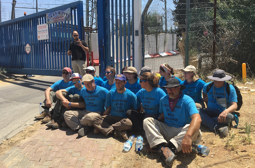 Ethan Buckner, second from left in front, and other activists from the Center for Jewish Nonviolence protesting outside the jail in the West Bank Jewish settlement Kiryat Arba, July 16, 2016. (Andrew Tobin)