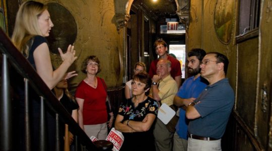 A group takes a tour of the Tenement Museum, which tells the stories of Jewish and other immigrants to New York, in 2008. (Kiko Niwa)