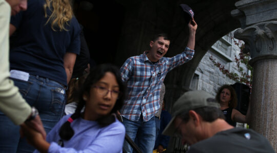 Louis Shenker protests outside of a town hall held by U.S. Sen. Elizabeth Warren in 2018. (Michael Swensen/The Boston Globe via Getty Images)