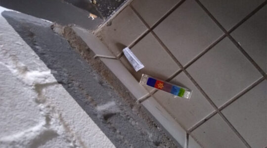 A vandalized mezuzah lies on the floor at the entrance to a Jewish student's home in Maastricht, the Netherlands on Feb. 18, 2021. (Stand With Us Netherlands)