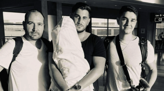 From left: Edouard David Benaym, Rudy Rochman, and Andrew Leibman pose with the Torah scroll before their trip to Nigeria. (Courtesy of We Were Never Lost)