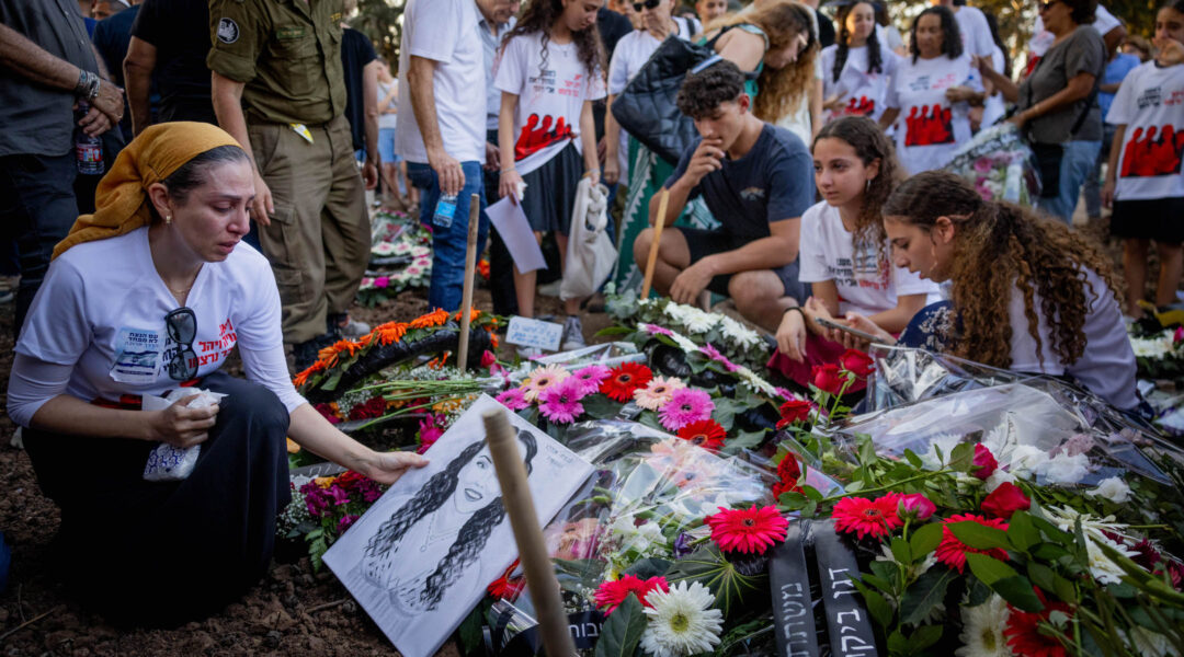 Family and friends attend the Oct. 25 funeral of three members of the Sharabi family, Lian, Noya and Yahel, who were murdered by Hamas terrorists in Kibbutz Be'eri on October 7, 2023. (Chaim Goldberg/Flash90)