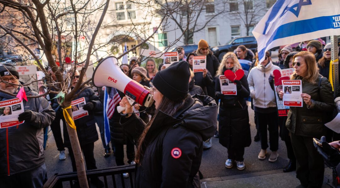 Protest leader Shany Granot-Lubaton heads a crowd outside the home of U.N. Secretary-General Antonio Guterres, January 5, 2024. (Luke Tress)