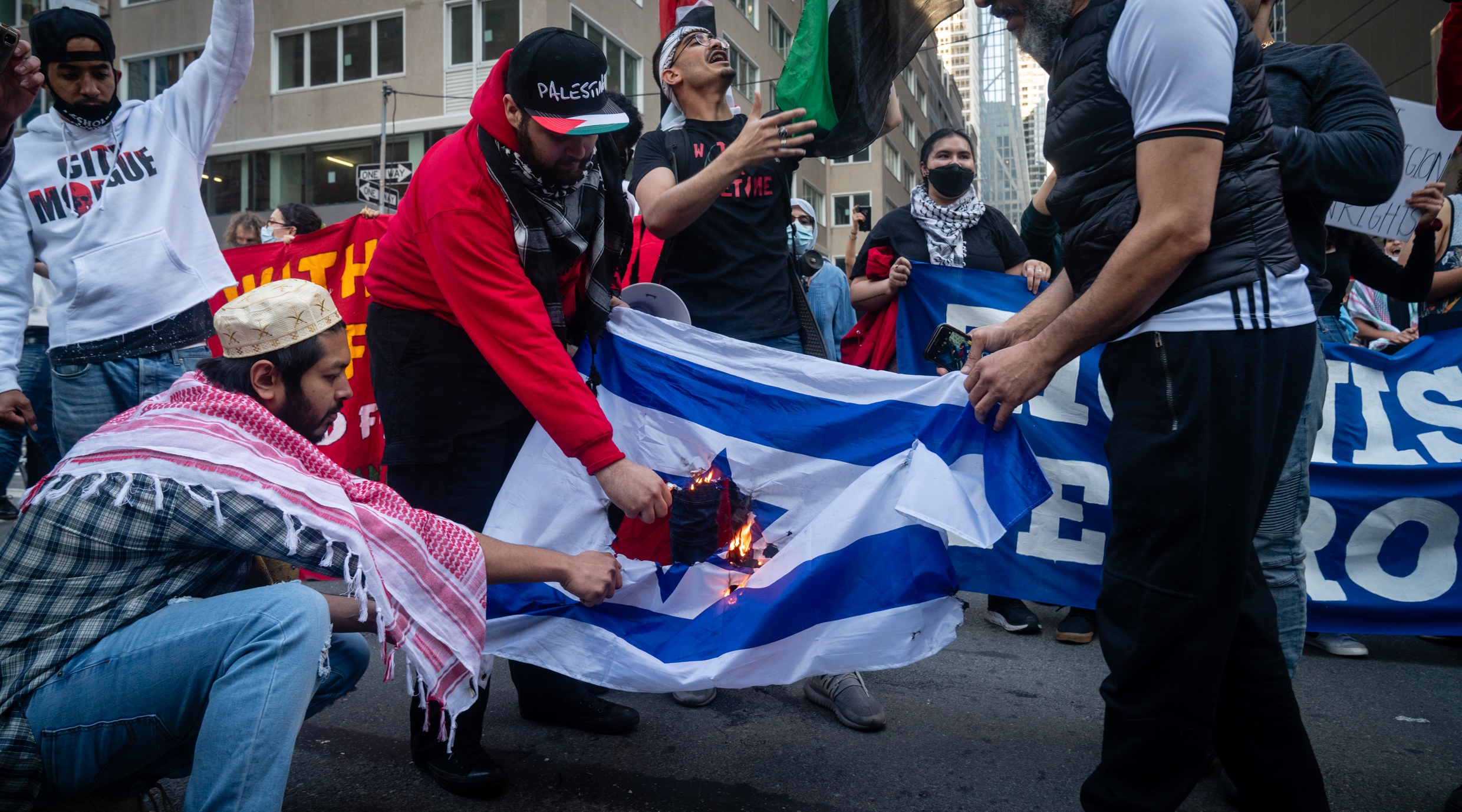 Protesters burn an Israeli flag at a demonstration led by Within Our Lifetime in Manhattan, May 14, 2021. (Luke Tress)