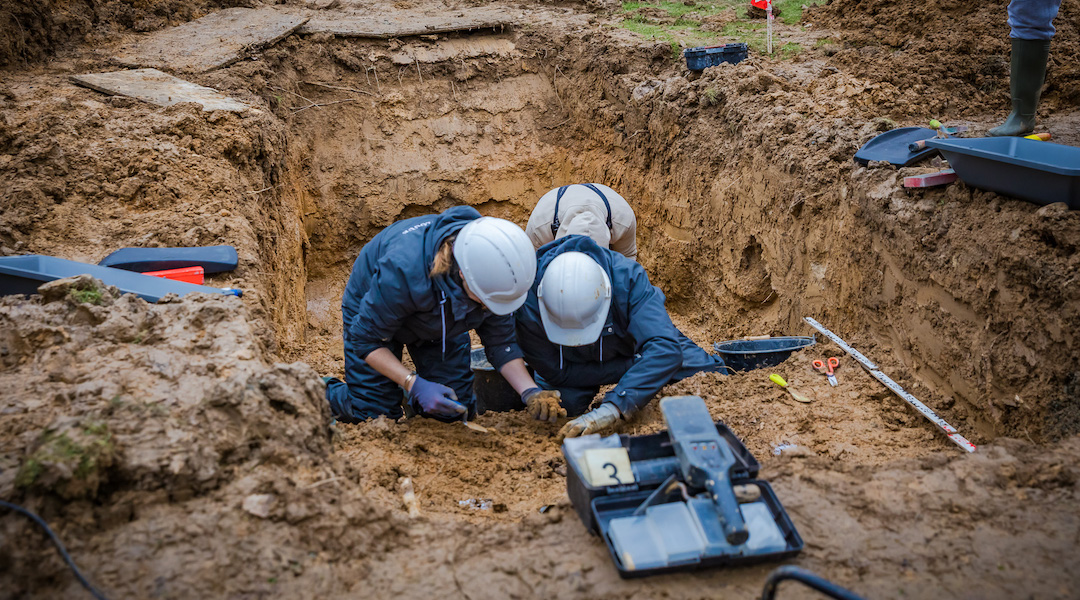 Excavators at a gravesite