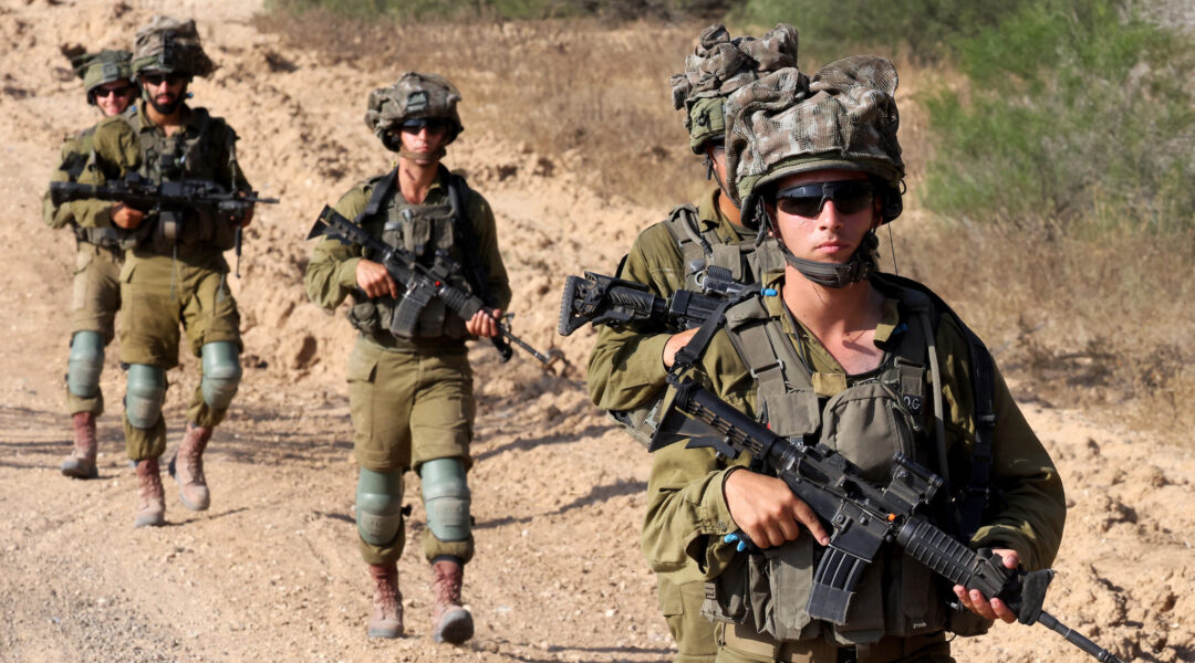 Israeli soldiers patrol around a position along Israel's southern border with the Gaza Strip on June 13, 2024. (Jack Guez / AFP)