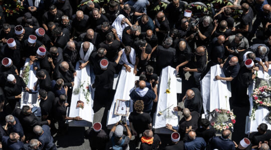 Thousands attend the funeral ceremony for children and teens killed in a rocket attack in Majdal Shams, Israel, on July 28, 2024. (Mostafa Alkharouf/Anadolu via Getty Images)
