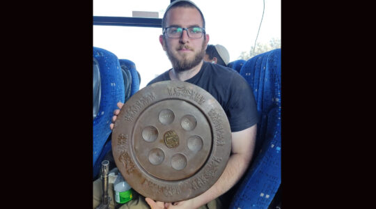 Or, a solider fighting in Gaza, displays a seder plate he found in the territory. (Courtesy of Or)