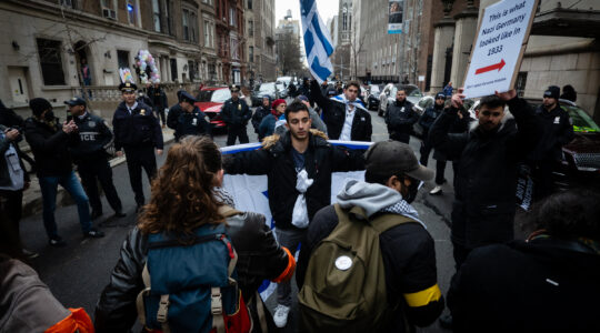 Anti-Israel activists block Jewish students from walking down a street near Columbia University, February 2, 2024. (Luke Tress)