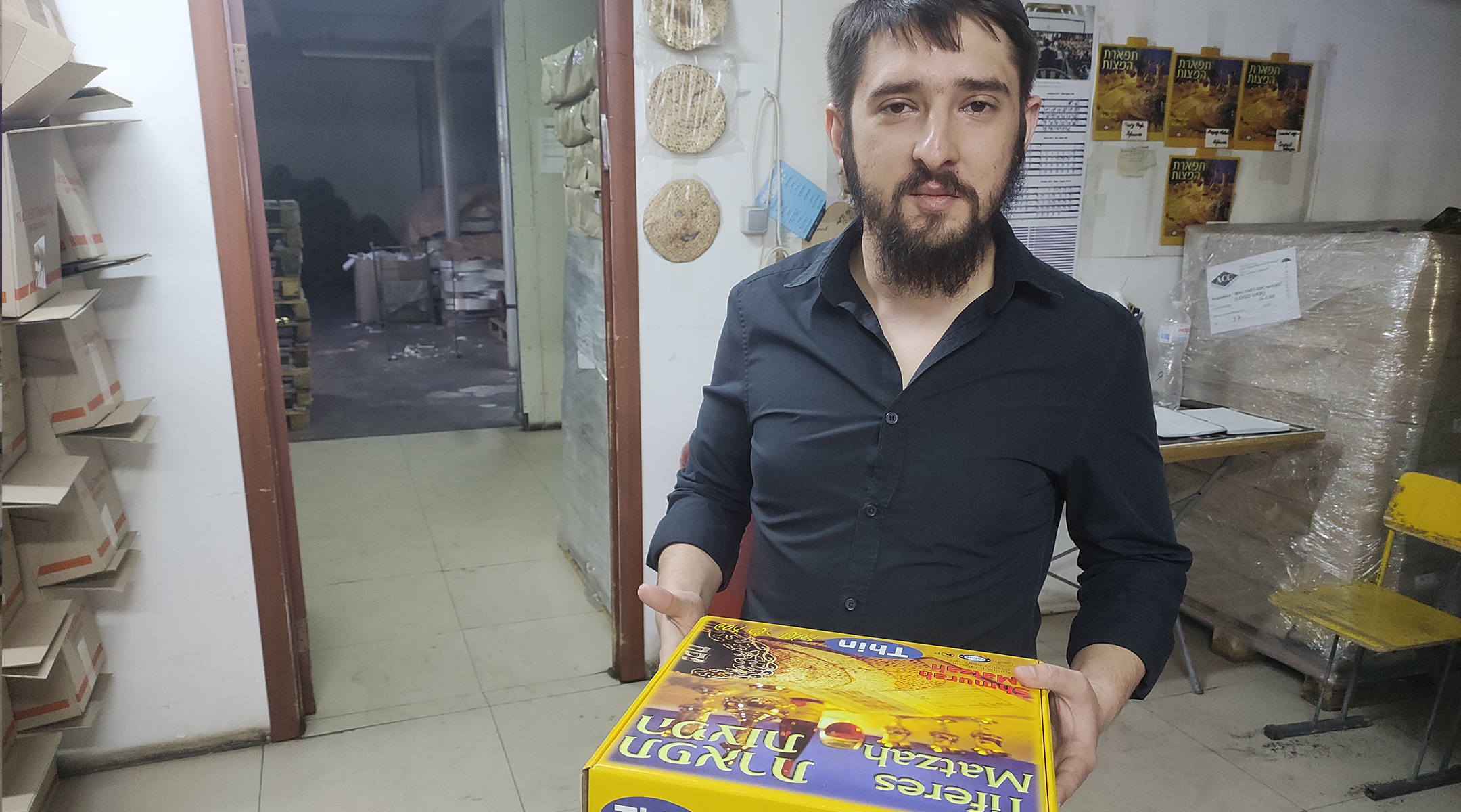 Daniel Ovcharenko with a box of matzah made at the factory in Dnipro.