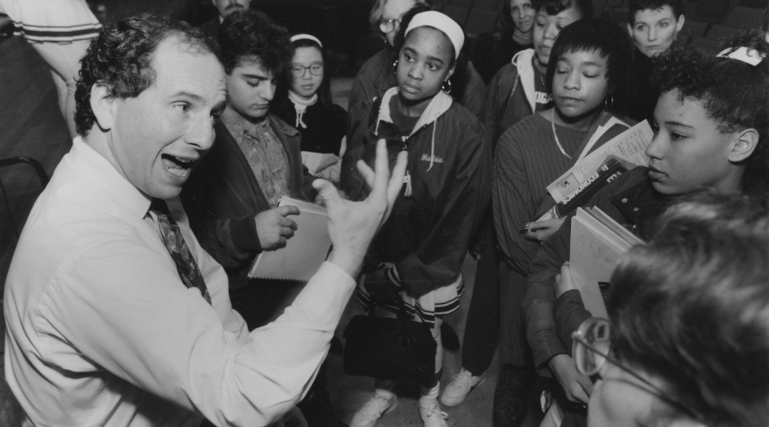 A senator animatedly talks to high school students