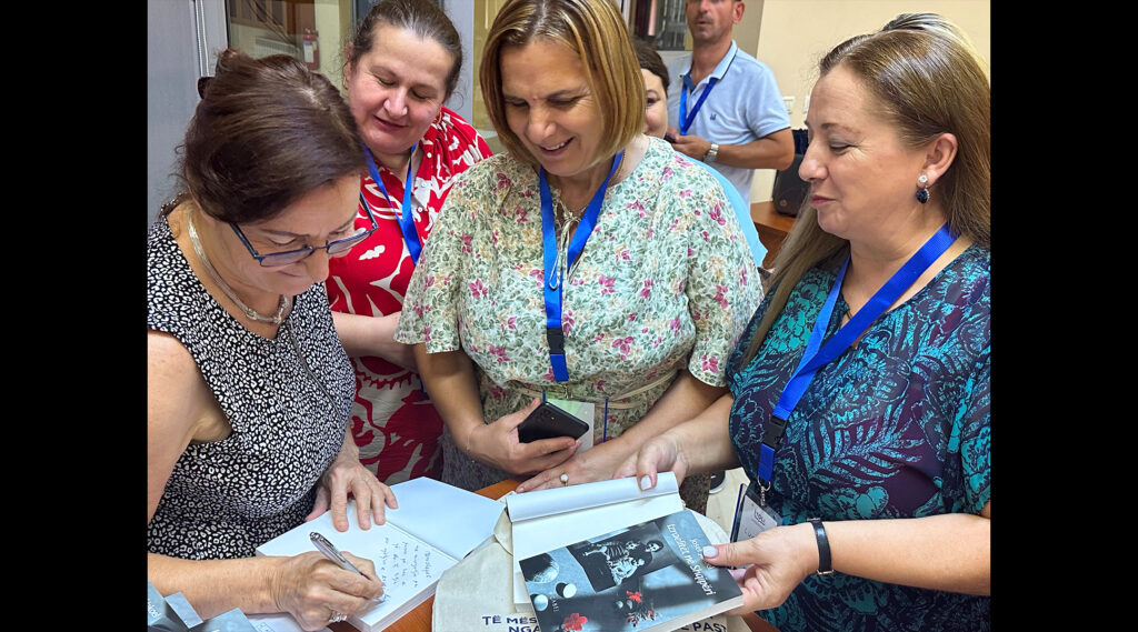 Felicita Jakoel autographs copies of her father's book.