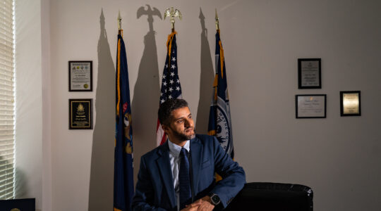 A mayor poses in his mayoral office