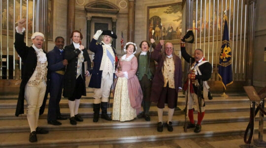 Actors wearing colonial clothes pose inside the National Archives Rotunda