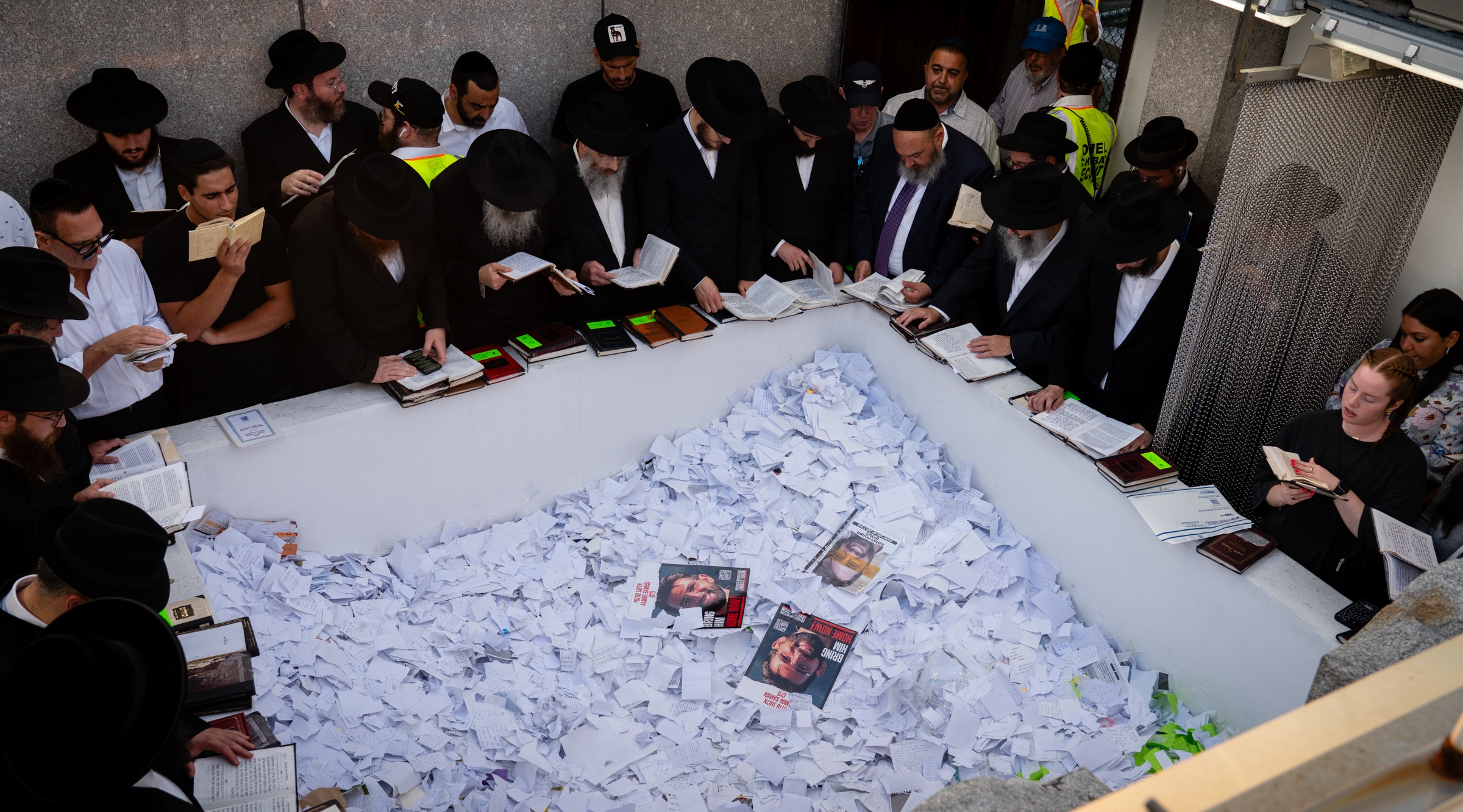 Hostage posters are placed among prayers at the gravesite of Chabad leader Rabbi Menachem Mendel Schneerson on the anniversary of his death, in Queens, July 9, 2024. (Luke Tress)