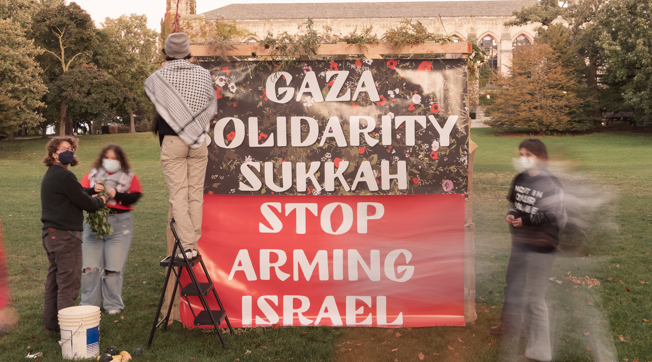 Students building a Gaza solidarity sukkah on a college campus