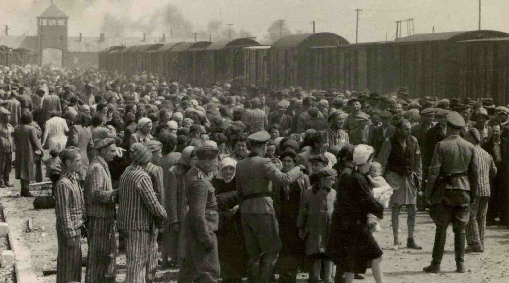 Historial image of Jews being led to trains during the Holocaust