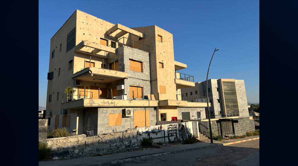 An apartment building bears scars from a wartime strike.