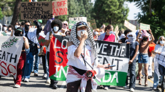 A large pro-Palestinian student protest with signs including "Long Live the Student Intifada"