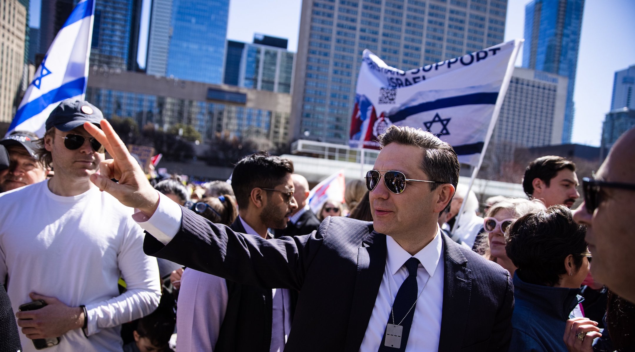 A politician waves at a pro-Israel rally