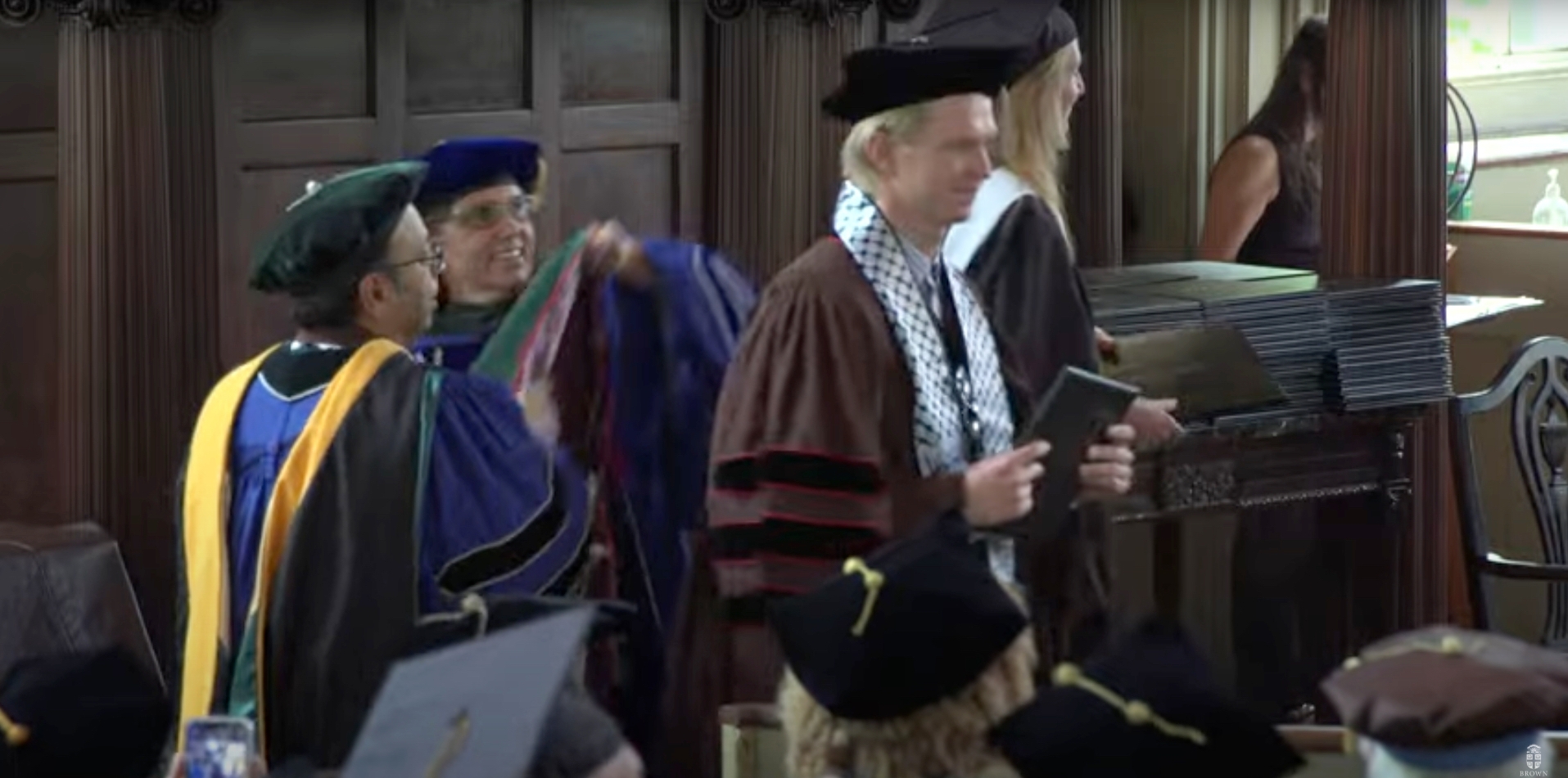 A graduating medical student wearing a keffiyeh