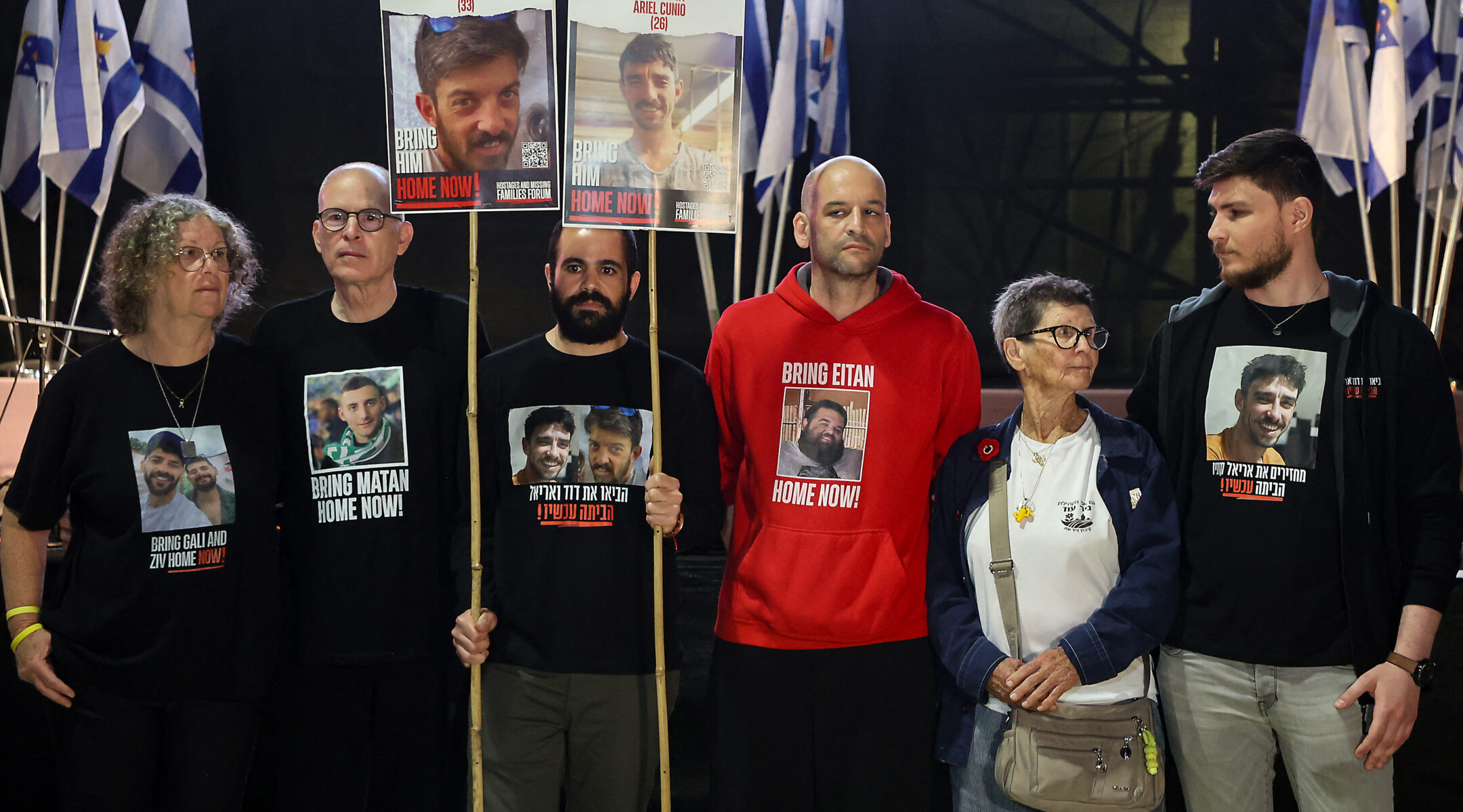 Freed Israeli hostages Aviva Siegel, Keith Siegel, Yarden Bibas, Yair Horn, Yocheved Lifshitz and Sasha Trufanov hold a protest calling for the end of the war and the release of the remaining Israeli hostages held captive in Gaza in Tel Aviv's Hostages Square, March 18, 2025. (Gil Cohen-Magen/AFP via Getty Images)